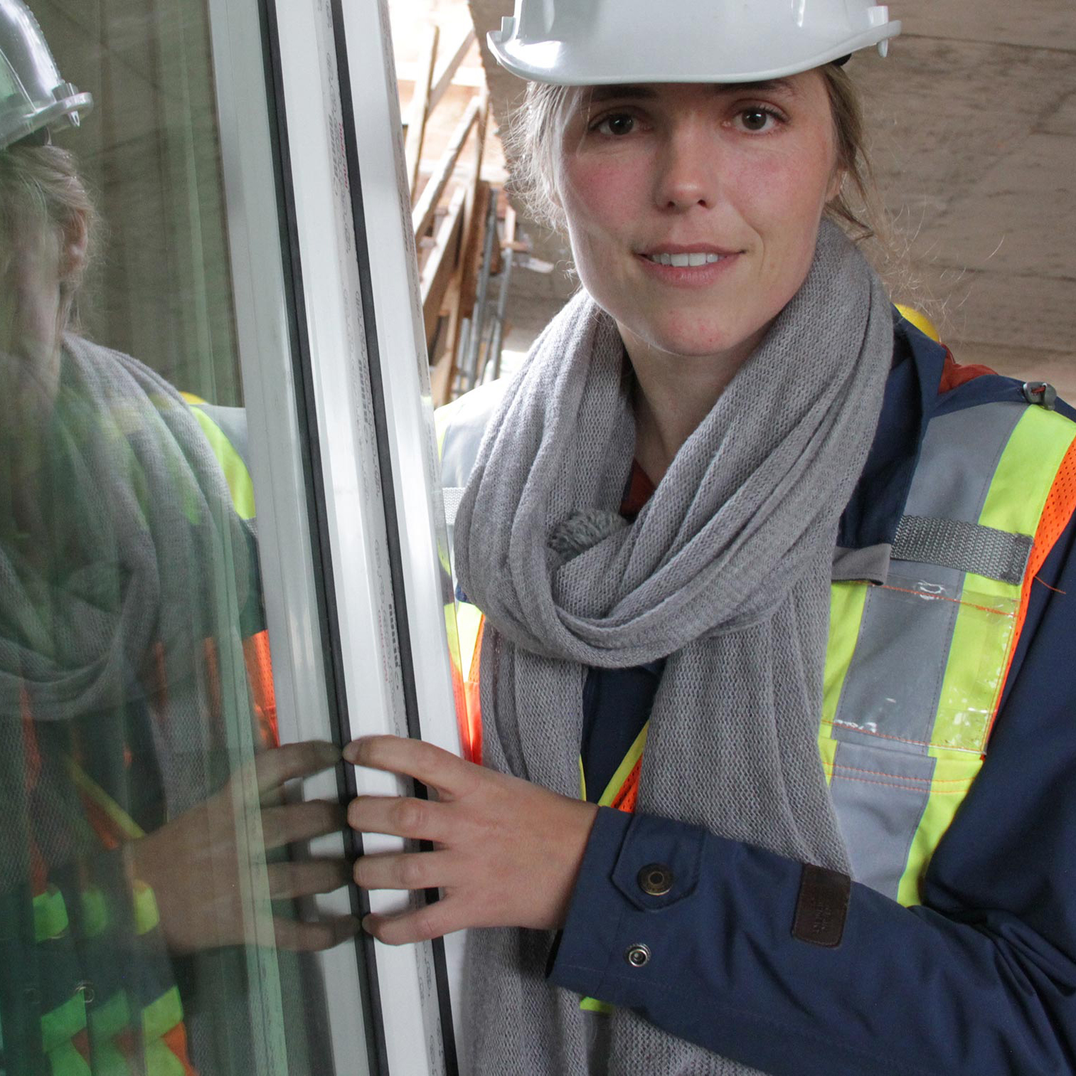 Woman in hard hat shows efficient window treatments. © David Dodge, made available under a Creative Commons 2.0 license.